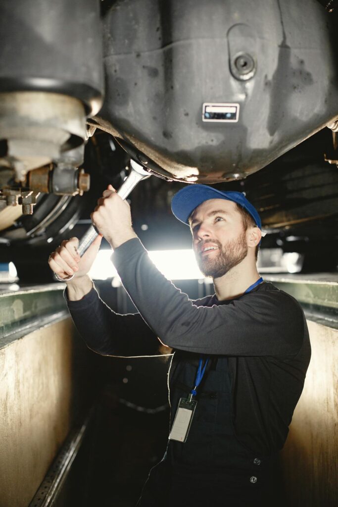 Technician performing Heavy Duty Transmission repair while wrenching on a truck transmission inside a repair shop