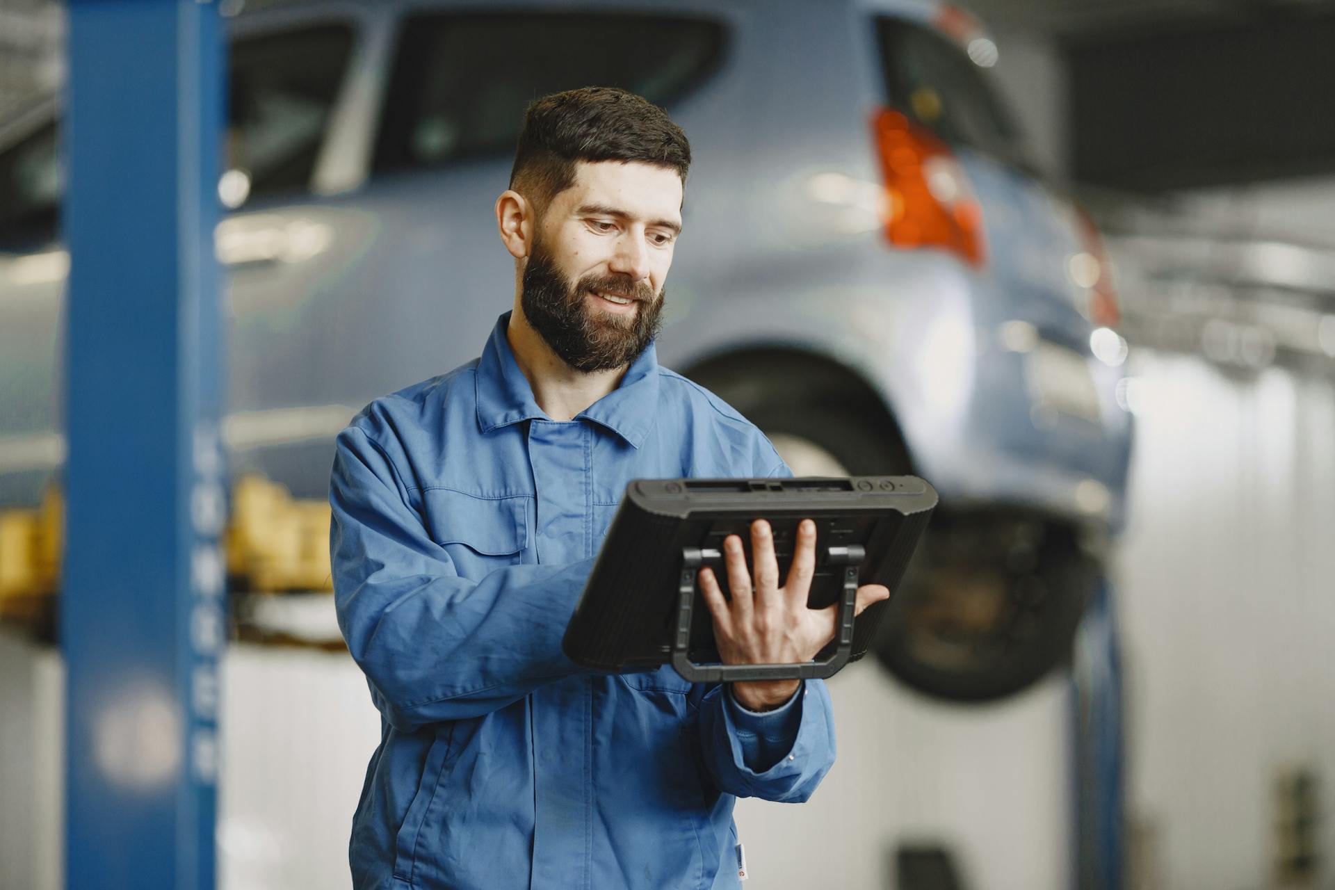 Transmission rebuild shop Reno technician smiling while working on vehicle repair